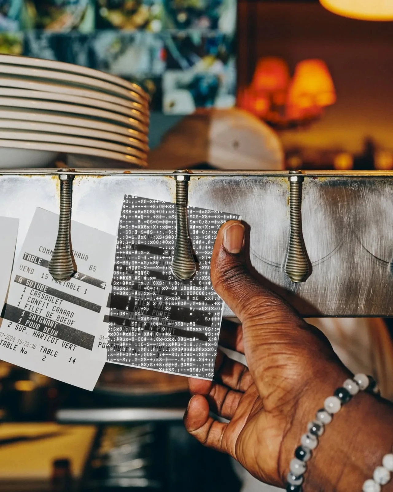 A restaurant worker coordinating a dense run of order tickets